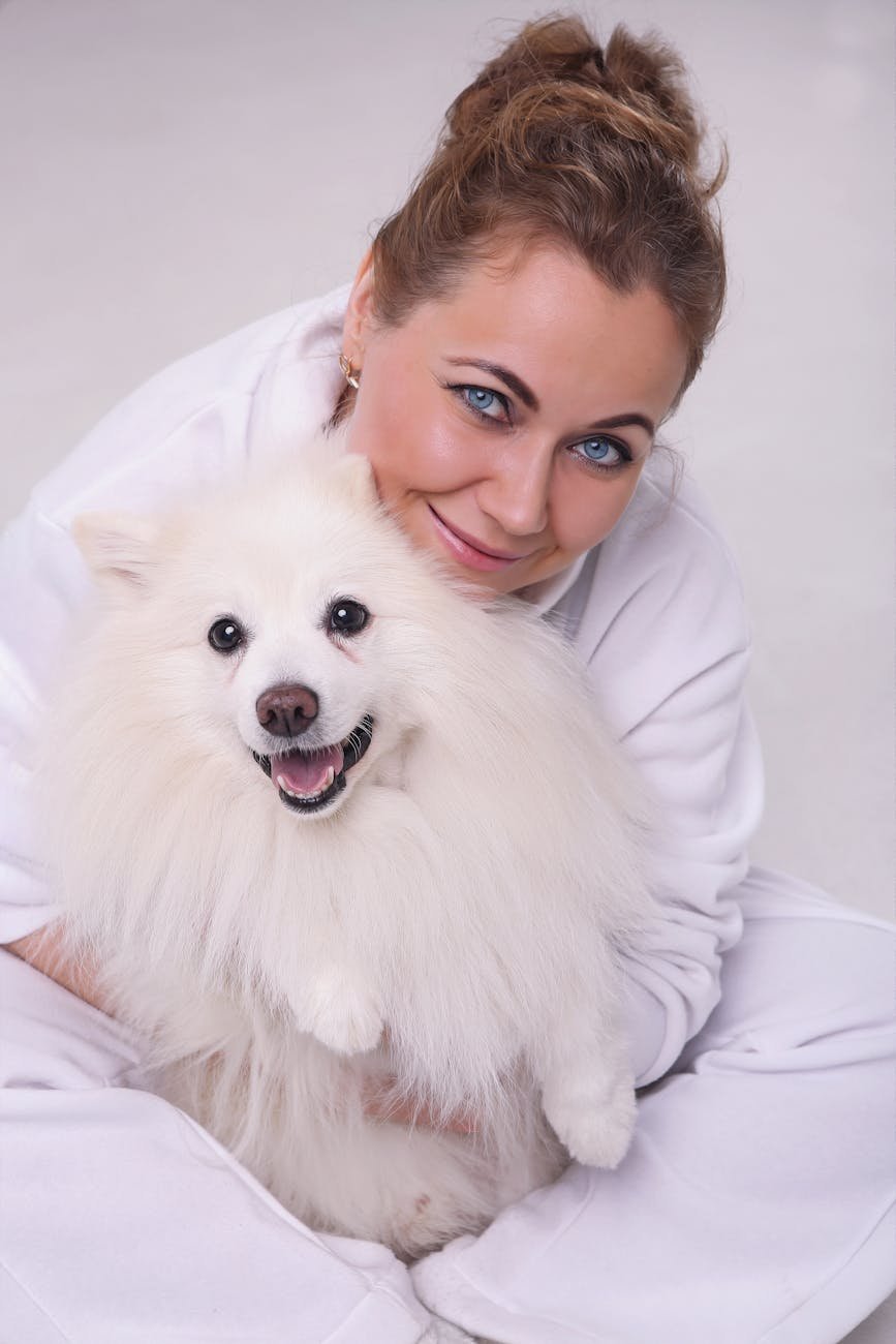 happy woman posing with pomeranian dog